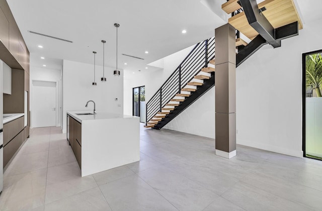 1233 NE 12th Ave Unit A, Fort Lauderdale, FL 33304 - kitchen with modern cabinets, a sink, light countertops, an island with sink, and recessed lighting