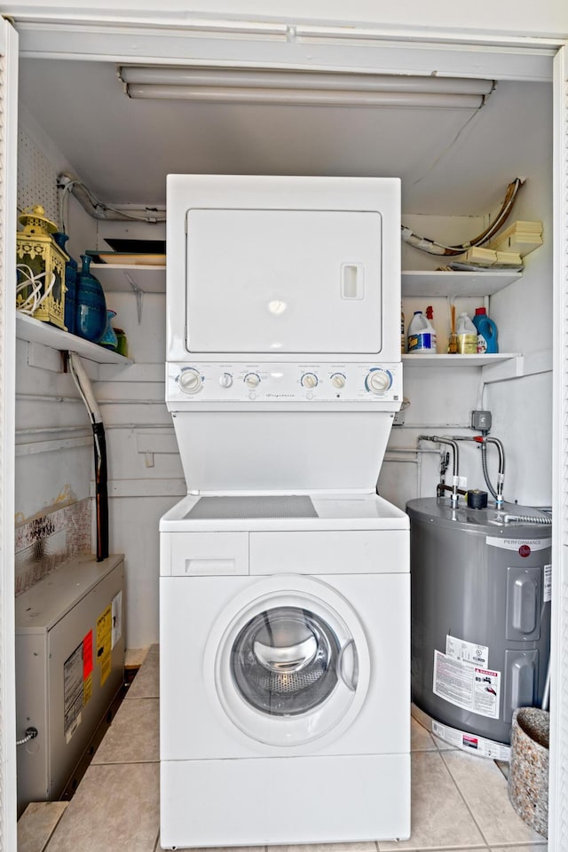 2121 NE 1st Ct Unit 202, Boynton Beach, FL 33435 - laundry room with stacked washer / drying machine, water heater, and light tile patterned floors