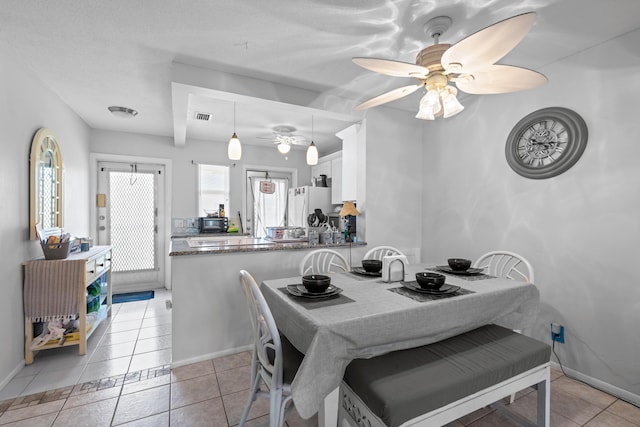 2121 NE 1st Ct Unit 202, Boynton Beach, FL 33435 - dining space with ceiling fan, light tile patterned floors, and baseboards