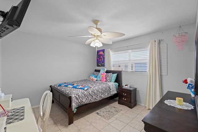 2121 NE 1st Ct Unit 202, Boynton Beach, FL 33435 - bedroom featuring light tile patterned flooring, ceiling fan, and a textured ceiling