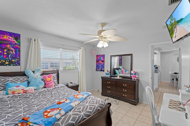 2121 NE 1st Ct Unit 202, Boynton Beach, FL 33435 - bedroom featuring light tile patterned floors, a ceiling fan, a textured ceiling, and baseboards
