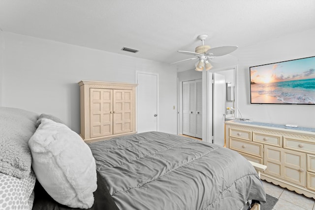 2121 NE 1st Ct Unit 202, Boynton Beach, FL 33435 - bedroom with ensuite bath, light tile patterned floors, ceiling fan, and a closet