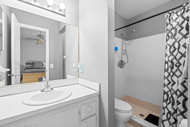2121 NE 1st Ct Unit 202, Boynton Beach, FL 33435 - ensuite bathroom with a tile shower, toilet, vanity, and a ceiling fan