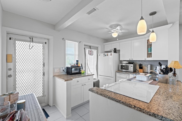 2121 NE 1st Ct Unit 202, Boynton Beach, FL 33435 - kitchen featuring white appliances, white cabinetry, a ceiling fan, tasteful backsplash, and beamed ceiling