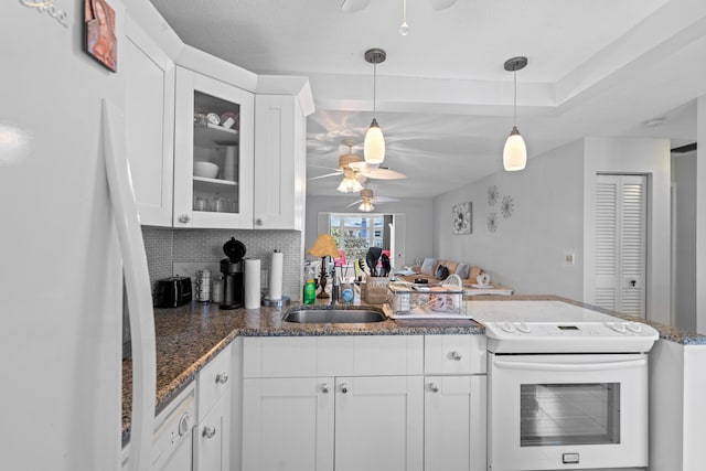2121 NE 1st Ct Unit 202, Boynton Beach, FL 33435 - kitchen featuring white appliances, a ceiling fan, a peninsula, and white cabinets