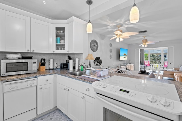 2121 NE 1st Ct Unit 202, Boynton Beach, FL 33435 - kitchen featuring white appliances, a peninsula, ceiling fan, glass insert cabinets, and backsplash