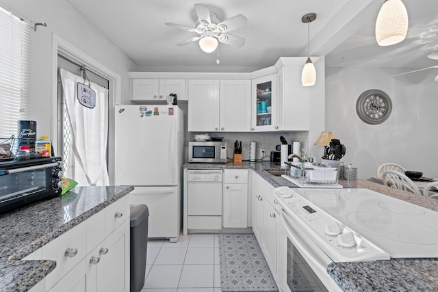 2121 NE 1st Ct Unit 202, Boynton Beach, FL 33435 - kitchen with white appliances, ceiling fan, glass insert cabinets, dark stone countertops, and white cabinetry