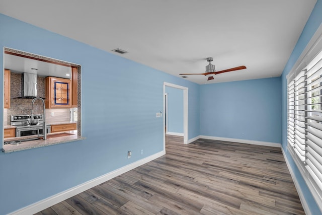 165 Cordoba Cir, Royal Palm Beach, FL 33411 - spare room featuring wood finished floors, a ceiling fan, and baseboards