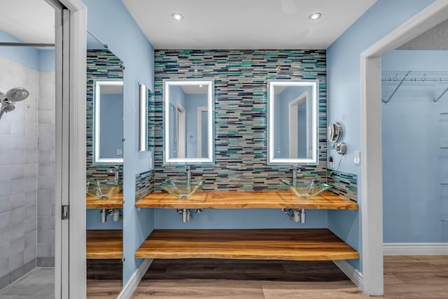 165 Cordoba Cir, Royal Palm Beach, FL 33411 - full bathroom featuring a sink, wood finished floors, tiled shower, recessed lighting, and a walk in closet