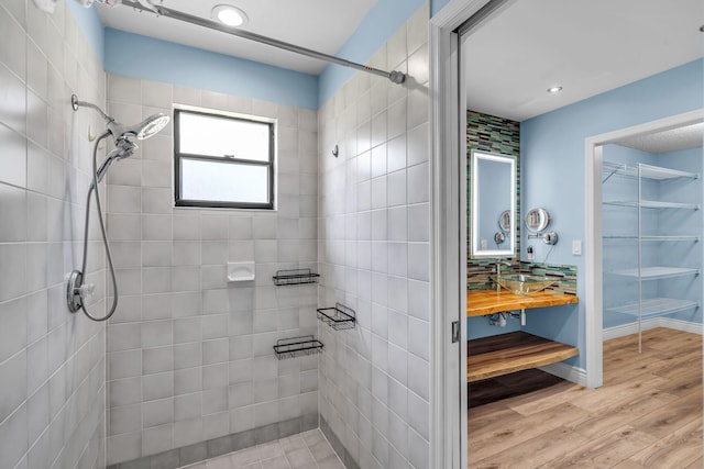 165 Cordoba Cir, Royal Palm Beach, FL 33411 - bathroom featuring tiled shower, wood finished floors, vanity, a spacious closet, and recessed lighting