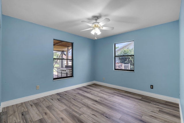 165 Cordoba Cir, Royal Palm Beach, FL 33411 - spare room featuring plenty of natural light, wood finished floors, a ceiling fan, and baseboards