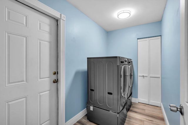 165 Cordoba Cir, Royal Palm Beach, FL 33411 - laundry room featuring separate washer and dryer, baseboards, and light wood-style floors