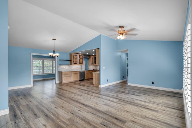 165 Cordoba Cir, Royal Palm Beach, FL 33411 - unfurnished living room featuring lofted ceiling, a chandelier, baseboards, a ceiling fan, and light wood-type flooring