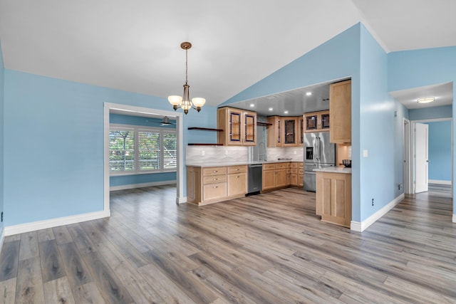 165 Cordoba Cir, Royal Palm Beach, FL 33411 - kitchen featuring stainless steel appliances, a chandelier, light wood-style floors, lofted ceiling, and baseboards