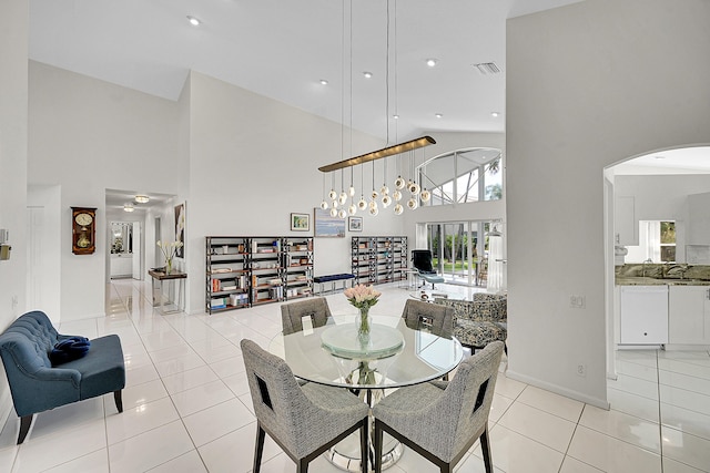 6078 Slice Ct, Boynton Beach, FL 33437 - dining space with a high ceiling, arched walkways, light tile patterned flooring, baseboards, and recessed lighting