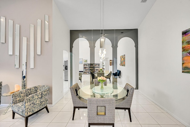 6078 Slice Ct, Boynton Beach, FL 33437 - dining area featuring decorative columns, arched walkways, and light tile patterned flooring