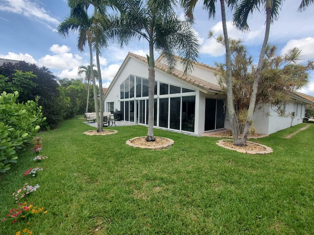 6078 Slice Ct, Boynton Beach, FL 33437 - back of property featuring stucco siding, a lawn, a tiled roof, and a sunroom