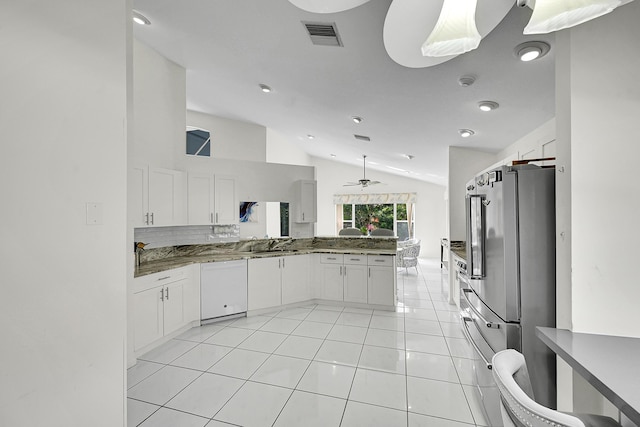 6078 Slice Ct, Boynton Beach, FL 33437 - kitchen with lofted ceiling, freestanding refrigerator, white dishwasher, a peninsula, and white cabinetry
