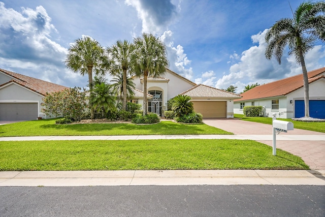 6078 Slice Ct, Boynton Beach, FL 33437 - mediterranean / spanish house featuring stucco siding, an attached garage, a front yard, driveway, and a tile roof