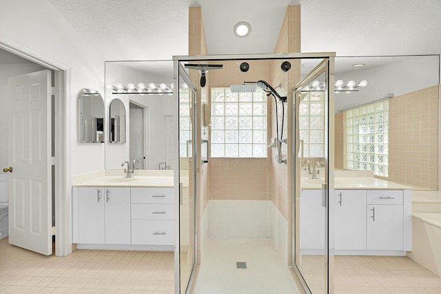 6078 Slice Ct, Boynton Beach, FL 33437 - bathroom featuring a shower stall, tile patterned flooring, and two vanities