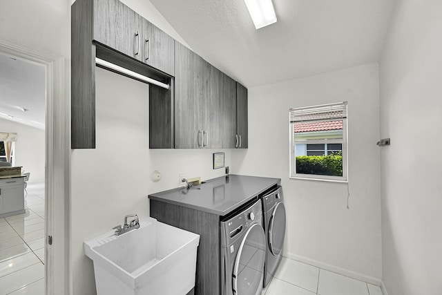 6078 Slice Ct, Boynton Beach, FL 33437 - laundry area featuring cabinet space, washing machine and dryer, light tile patterned floors, and baseboards