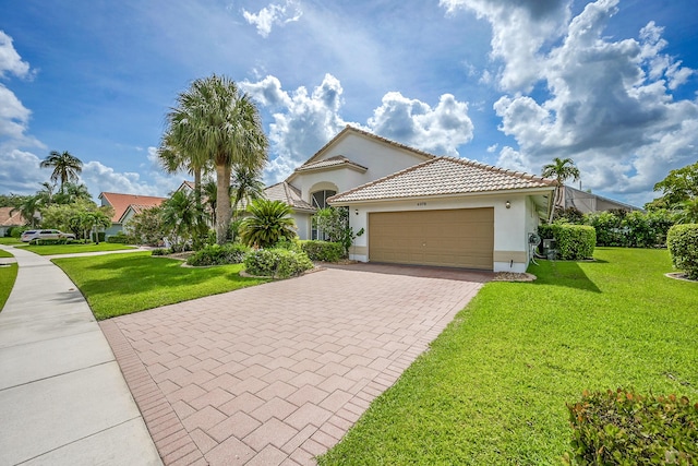 6078 Slice Ct, Boynton Beach, FL 33437 - mediterranean / spanish house with stucco siding, a garage, decorative driveway, and a front lawn