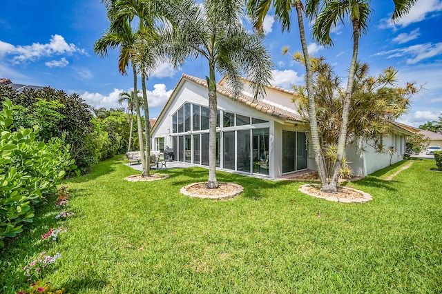 6078 Slice Ct, Boynton Beach, FL 33437 - back of house with stucco siding, a tile roof, a yard, and a patio