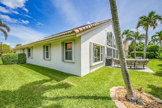 6078 Slice Ct, Boynton Beach, FL 33437 - view of home's exterior with stucco siding, a yard, a patio area, outdoor lounge area, and a tile roof