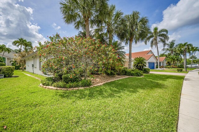 6078 Slice Ct, Boynton Beach, FL 33437 - view of property exterior with concrete driveway, a lawn, and stucco siding