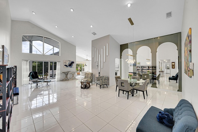6078 Slice Ct, Boynton Beach, FL 33437 - tiled dining space with high vaulted ceiling, arched walkways, recessed lighting, and a chandelier