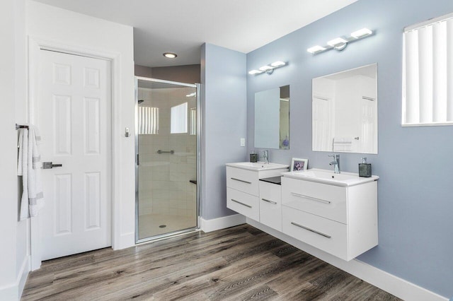 2802 Waters Edge Cir, Greenacres, FL 33413 - bathroom with a shower stall, vanity, wood finished floors, baseboards, and recessed lighting