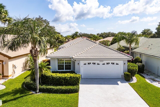 2802 Waters Edge Cir, Greenacres, FL 33413 - view of front of property with an attached garage, stucco siding, concrete driveway, a front yard, and a tiled roof