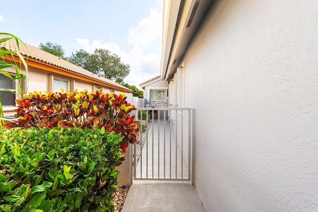 2802 Waters Edge Cir, Greenacres, FL 33413 - view of side of property featuring stucco siding and a gate