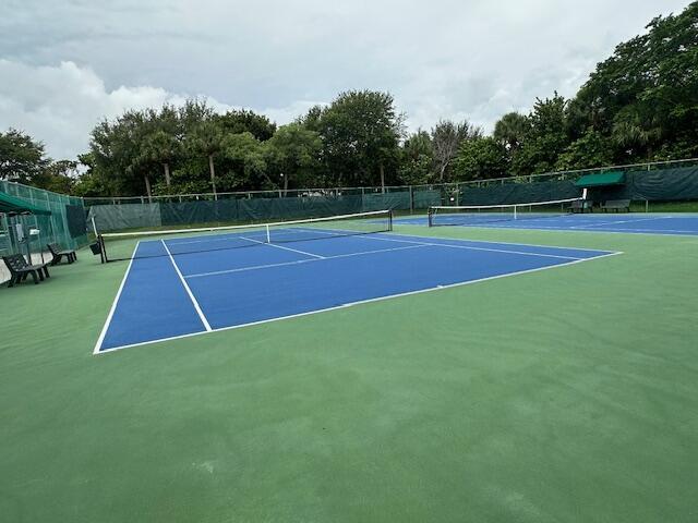 2802 Waters Edge Cir, Greenacres, FL 33413 - view of tennis court with view of wooded area