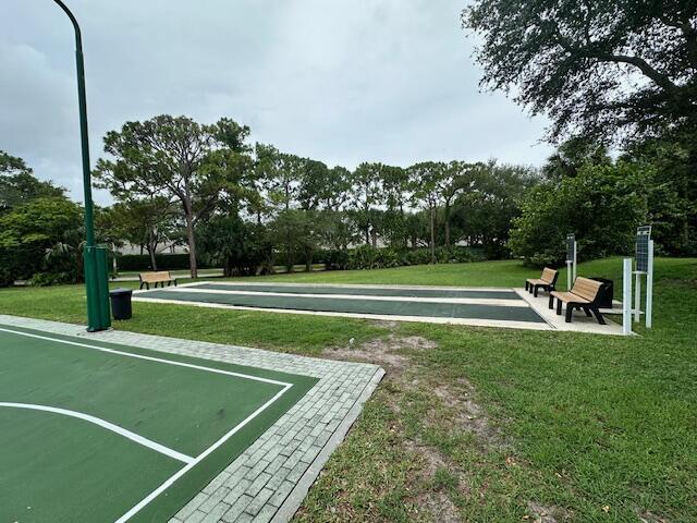 2802 Waters Edge Cir, Greenacres, FL 33413 - view of home's community featuring a yard, shuffleboard, and view of wooded area