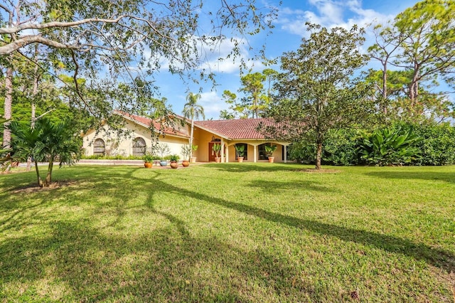 11357 Roselynn Way, Lake Worth, FL 33449 - view of front of property featuring stucco siding, a tiled roof, and a front lawn