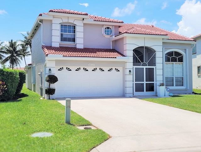 12484 Pleasant Green Way, Boynton Beach, FL 33437 - mediterranean / spanish home with a tile roof, concrete driveway, a front lawn, and stucco siding