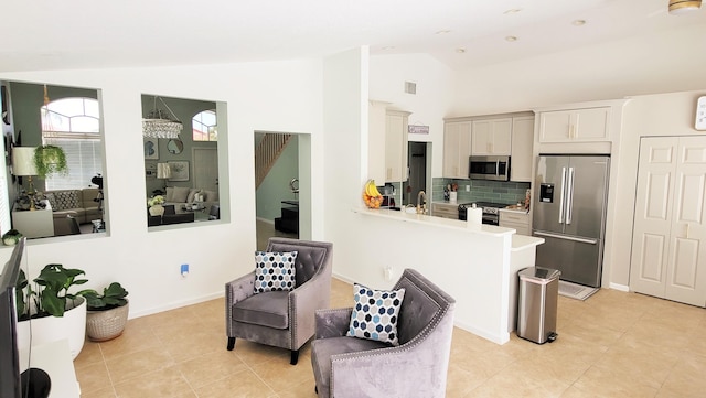 12484 Pleasant Green Way, Boynton Beach, FL 33437 - kitchen with stainless steel appliances, lofted ceiling, light countertops, tasteful backsplash, and light tile patterned floors