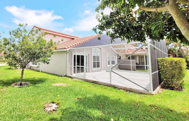 12484 Pleasant Green Way, Boynton Beach, FL 33437 - rear view of property featuring a tiled roof, a lawn, a patio area, stucco siding, and a lanai