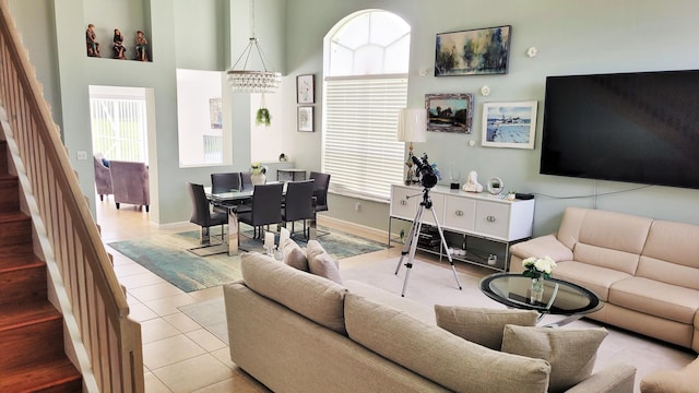 12484 Pleasant Green Way, Boynton Beach, FL 33437 - tiled living area featuring stairway, baseboards, and a towering ceiling