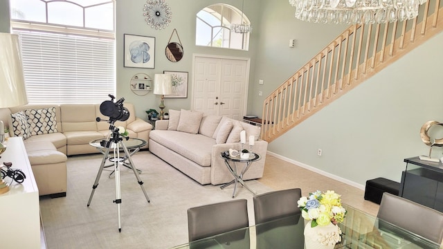 12484 Pleasant Green Way, Boynton Beach, FL 33437 - living room featuring stairway, healthy amount of natural light, baseboards, and a towering ceiling