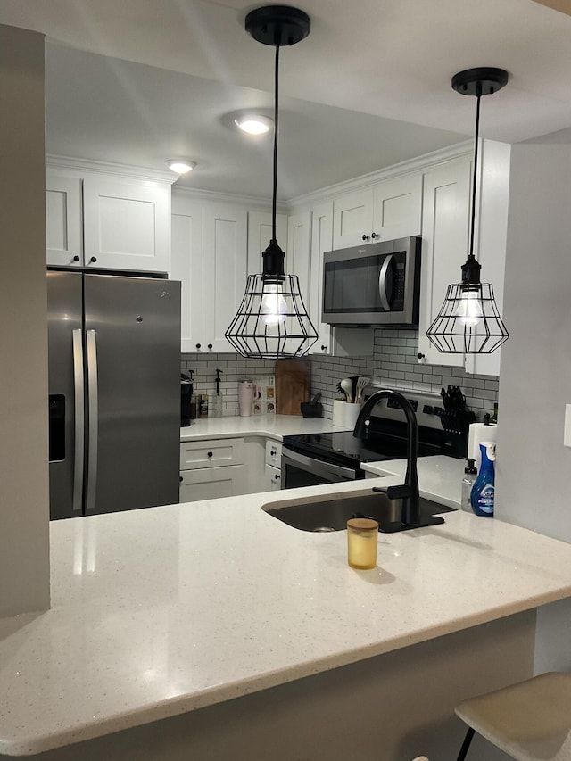1530 SE Royal Green Cir Unit N103, Port Saint Lucie, FL 34952 - kitchen featuring appliances with stainless steel finishes, a sink, backsplash, and light stone counters