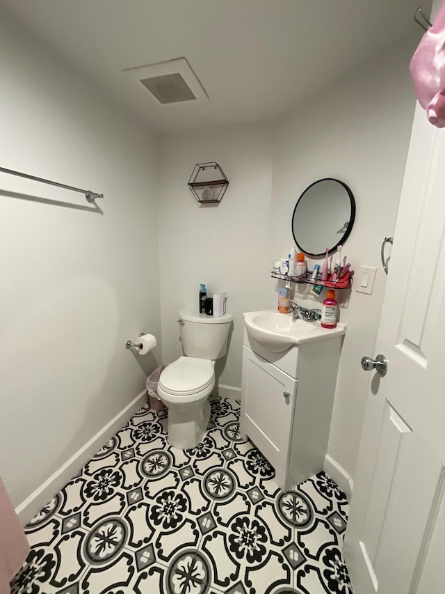 1530 SE Royal Green Cir Unit N103, Port Saint Lucie, FL 34952 - bathroom featuring baseboards, vanity, toilet, and tile patterned flooring