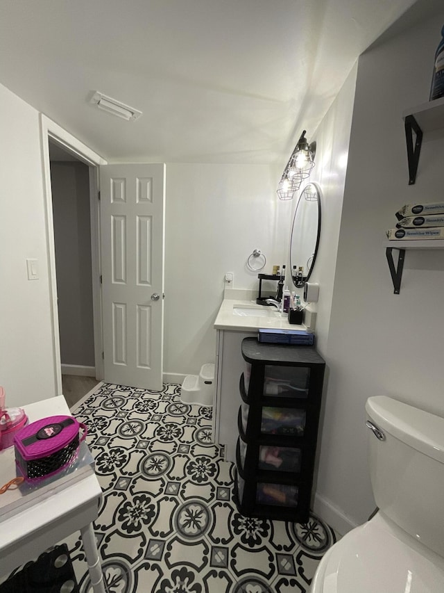 1530 SE Royal Green Cir Unit N103, Port Saint Lucie, FL 34952 - half bathroom with toilet, vanity, baseboards, and tile patterned flooring