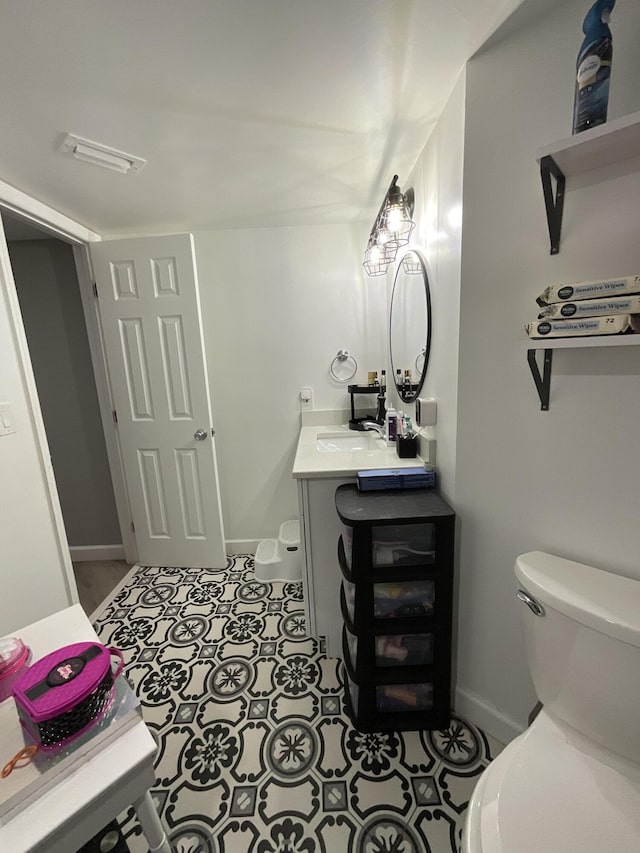 1530 SE Royal Green Cir Unit N103, Port Saint Lucie, FL 34952 - half bathroom featuring toilet, vanity, baseboards, and tile patterned flooring