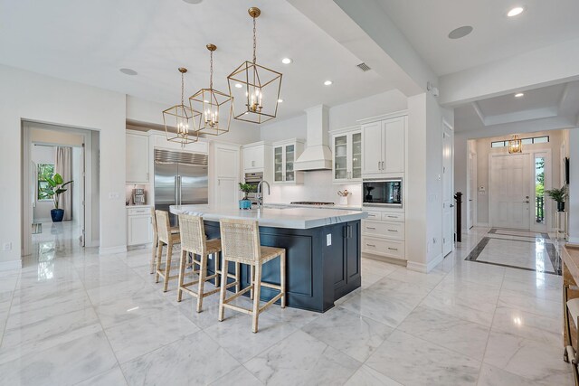 8164 SE Old Plantation Cir, Jupiter, FL 33458 - kitchen with a chandelier, built in appliances, decorative backsplash, baseboards, and light marble finish flooring