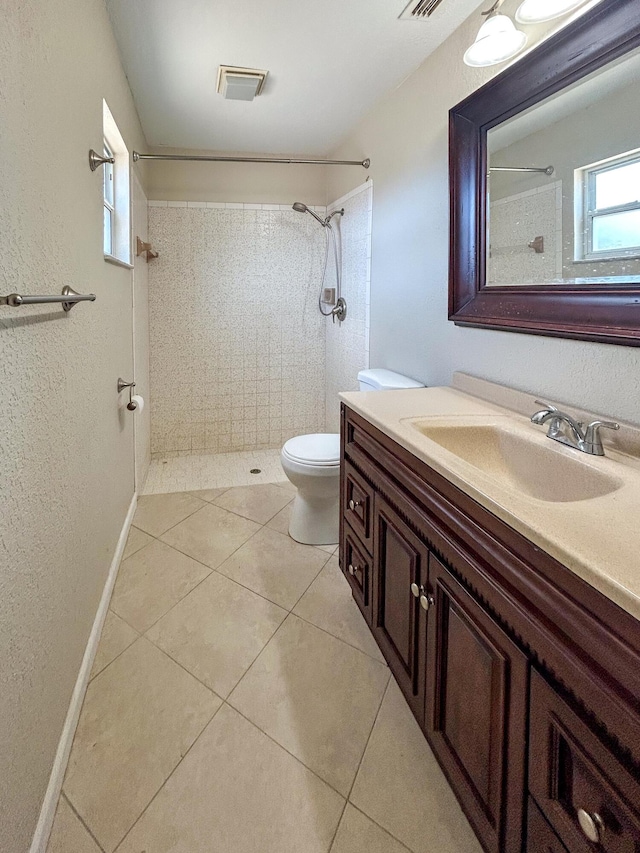 1712 SW Airoso Blvd, Port Saint Lucie, FL 34984 - full bathroom featuring toilet, a tile shower, vanity, and tile patterned flooring