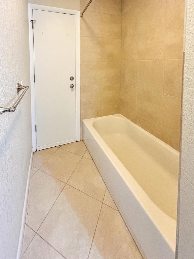 1712 SW Airoso Blvd, Port Saint Lucie, FL 34984 - bathroom with tile patterned floors, a textured wall, and shower / tub combination