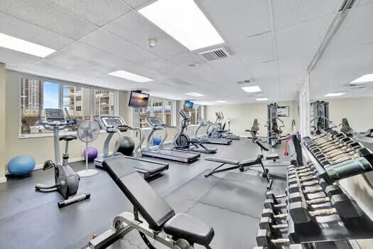 111 N N Pompano Beach Blvd Unit 411, Pompano Beach, FL 33062 - gym with healthy amount of natural light and a drop ceiling