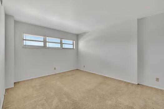 111 N N Pompano Beach Blvd Unit 411, Pompano Beach, FL 33062 - unfurnished room featuring light carpet
